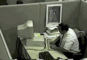 Frustrated computer user taking his anger out on the computer