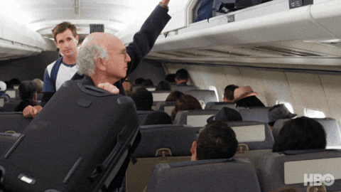 Meme: Curb Your Enthusiasm, putting luggage in the overhead bin